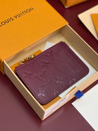 Small leather pouch bag with burgundy monogram and gold zipper pull