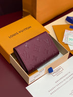 Small Louis Vuitton monogram bag in dark plum leather with front flap and gold button