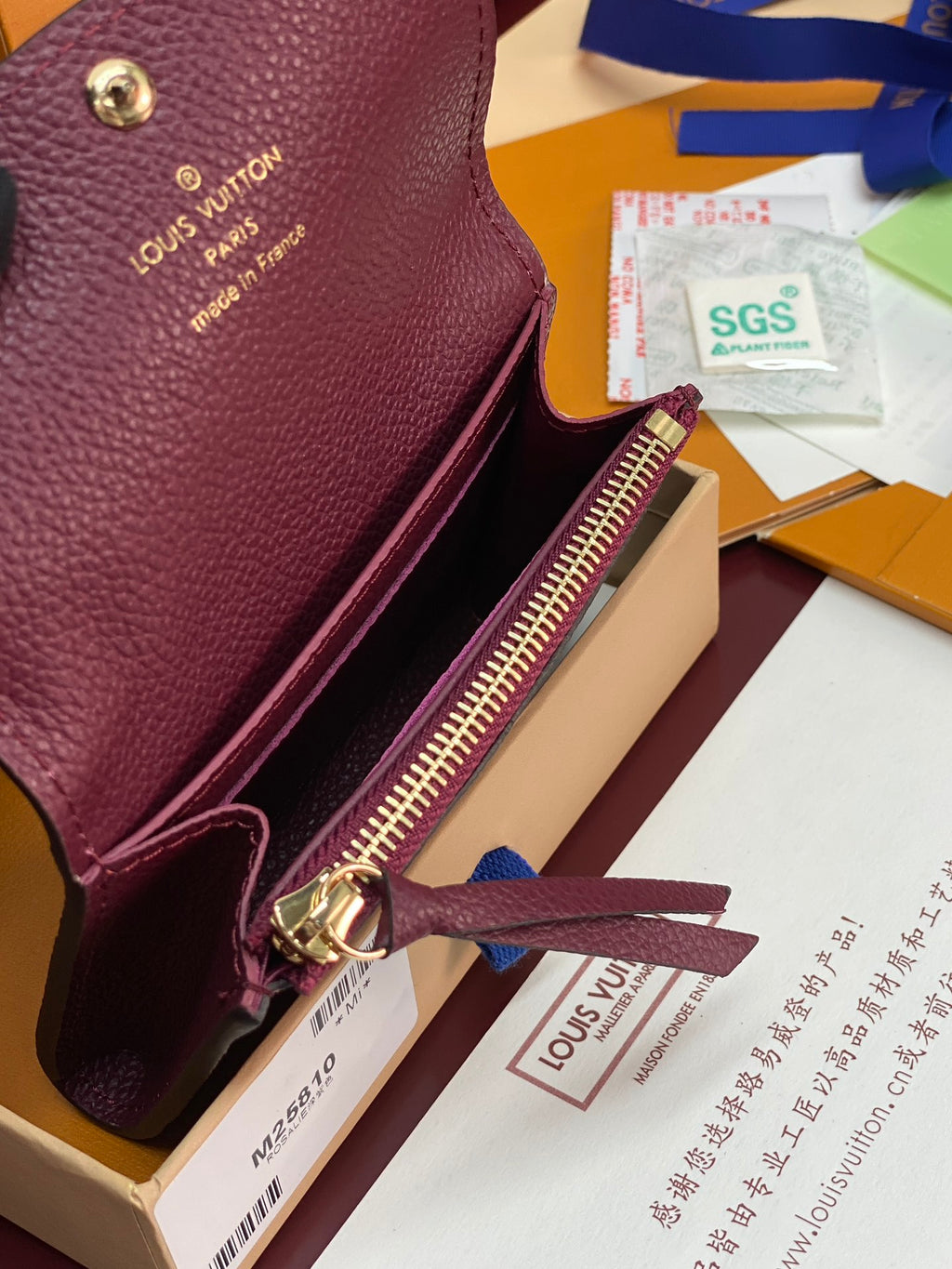 Small Louis Vuitton monogram bag with open top and gold zipper pull in dark plum leather