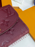 Small Louis Vuitton monogram leather bag, dark plum, textured grain and embossed motifs