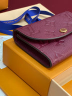 Small Louis Vuitton monogram bag with curved flap and gold snap on dark plum leather