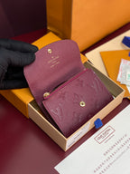 Small Louis Vuitton monogram bag with flap top and gold hardware in dark plum leather