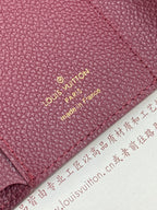 Louis Vuitton leather bag close-up with “Louis Vuitton Paris” stamp on burgundy