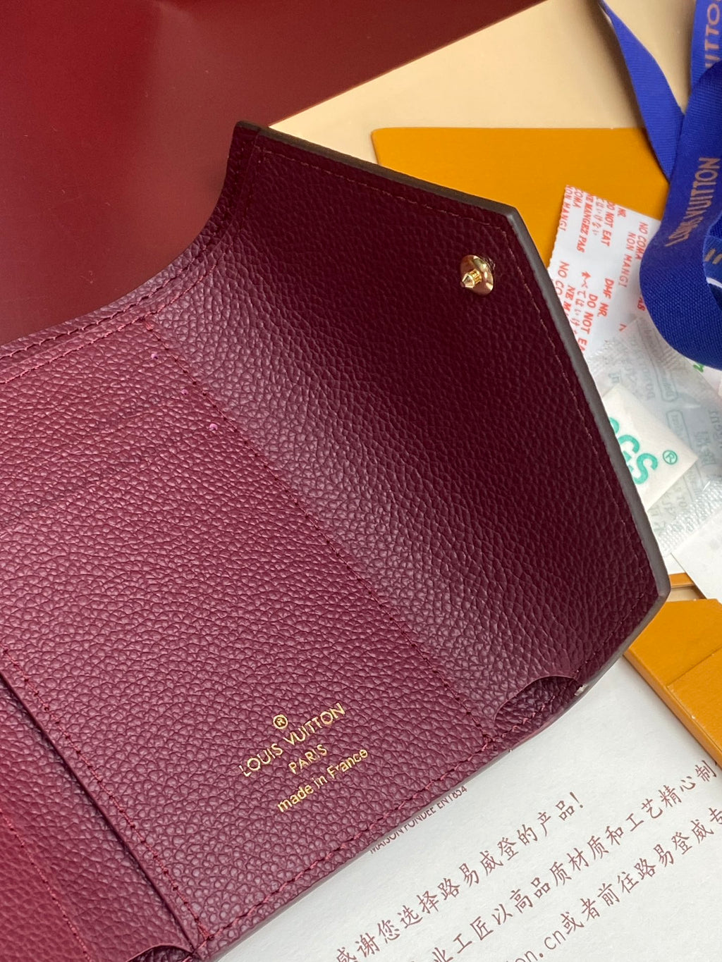 Louis Vuitton small card case bag in burgundy textured leather with gold clasp