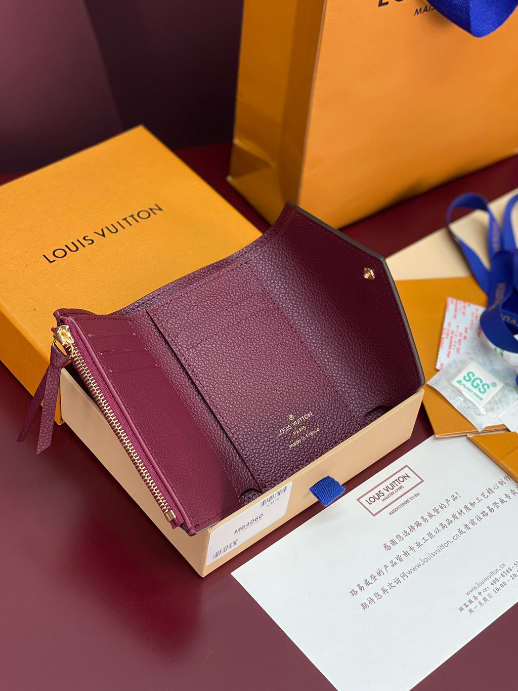 Louis Vuitton small wristlet bag in burgundy textured leather with gold hardware