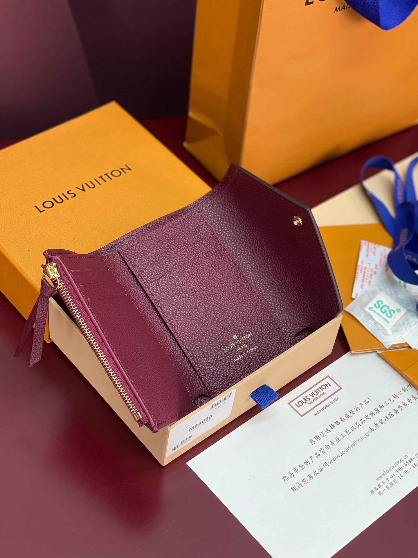 Louis Vuitton small wristlet bag in burgundy textured leather with gold hardware