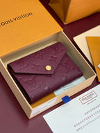Louis Vuitton small flap bag in burgundy textured leather with gold snap and fold