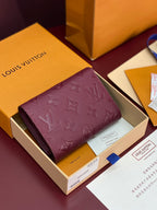 Louis Vuitton small fold-over bag in burgundy with raised monogram embossing