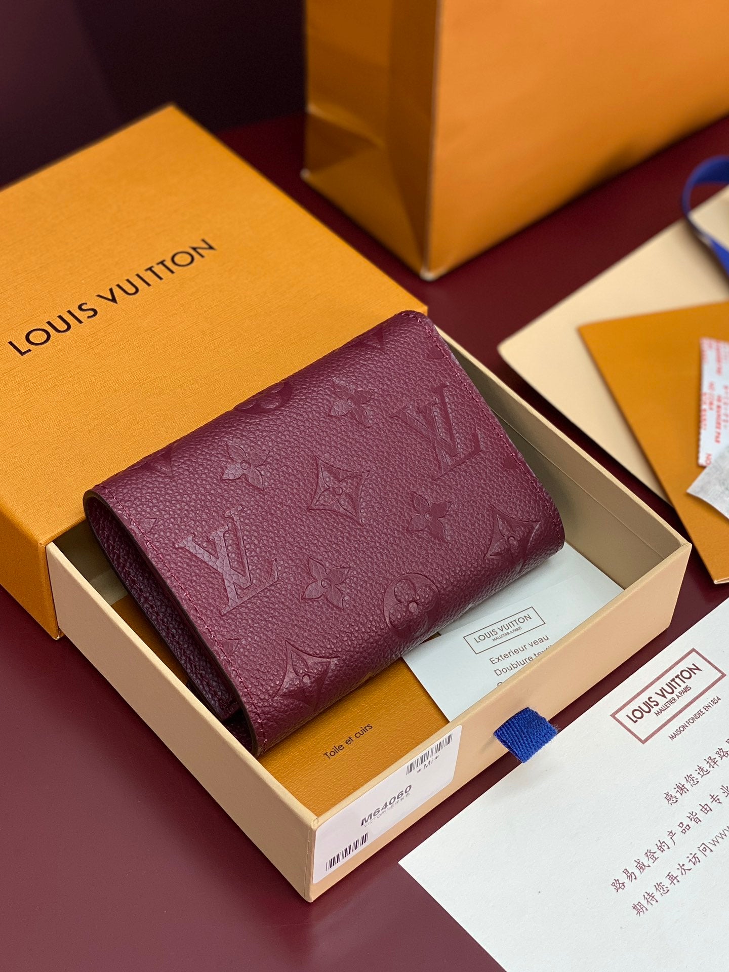 Louis Vuitton small fold-over bag in burgundy with raised monogram embossing