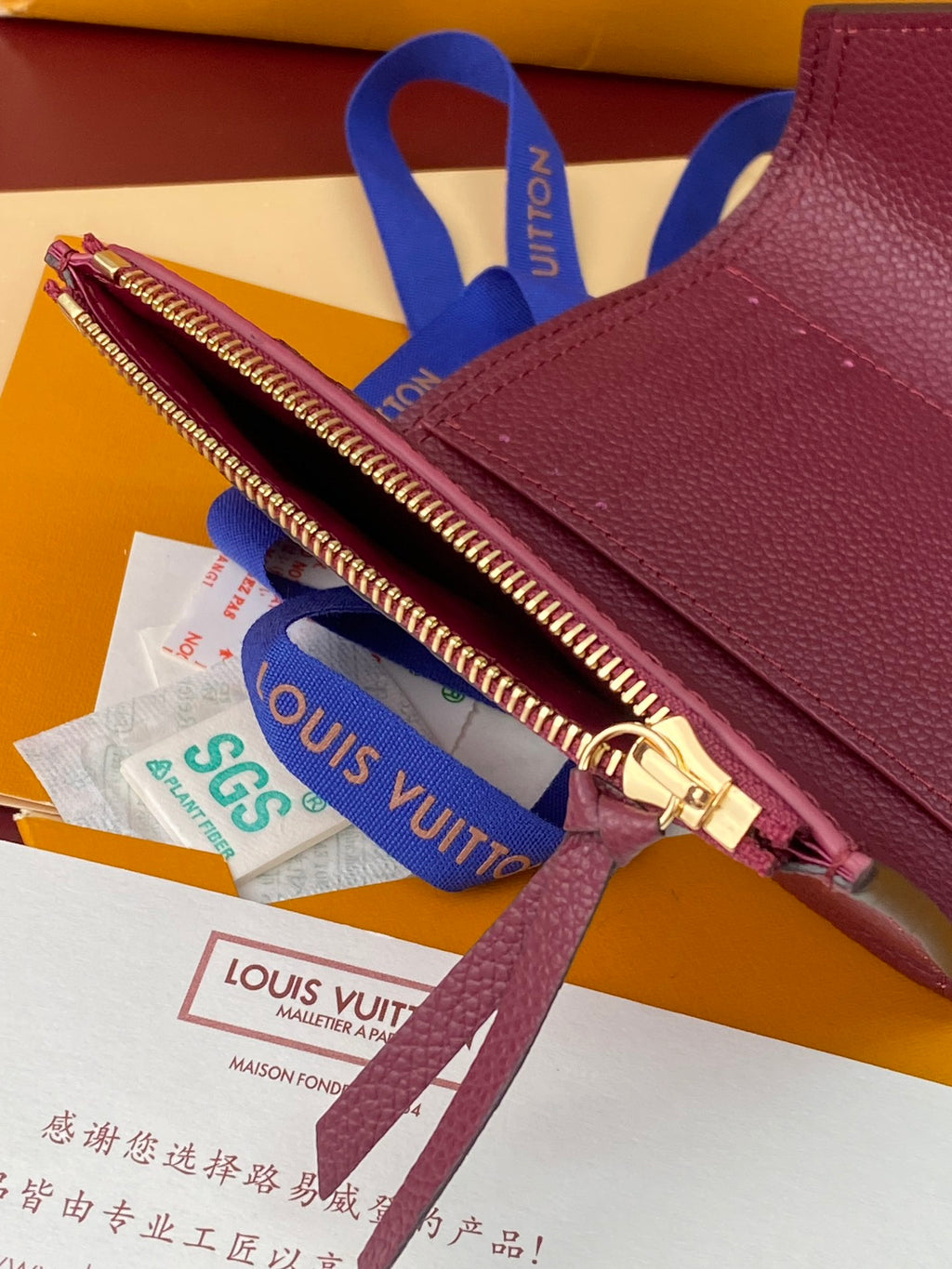 Louis Vuitton small zip pouch bag in burgundy with gold zipper and ribbon tags