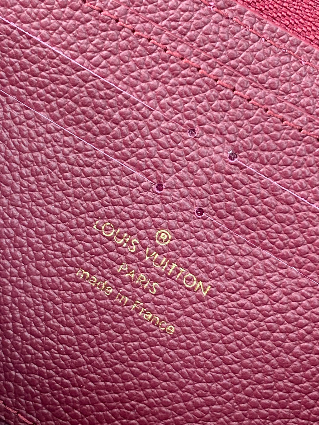 Small purple Louis Vuitton monogram leather with gold embossed logo lettering.