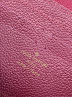 Small purple Louis Vuitton monogram leather with gold embossed logo lettering.