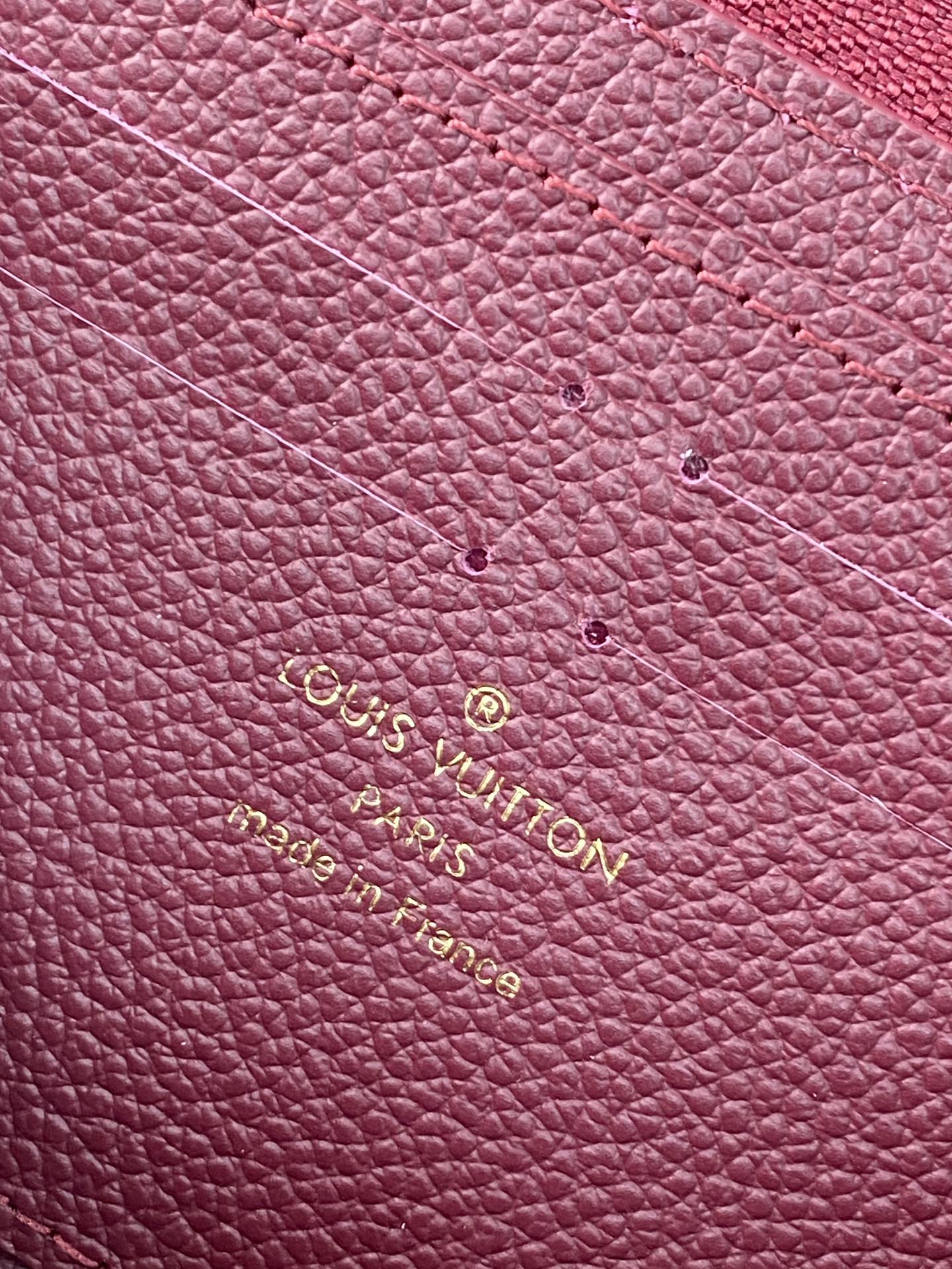 Small purple Louis Vuitton monogram leather with gold embossed logo lettering.