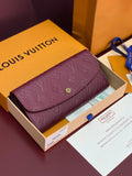 Small bag with flap, burgundy/purple embossed monogram texture and gold clasp detail.