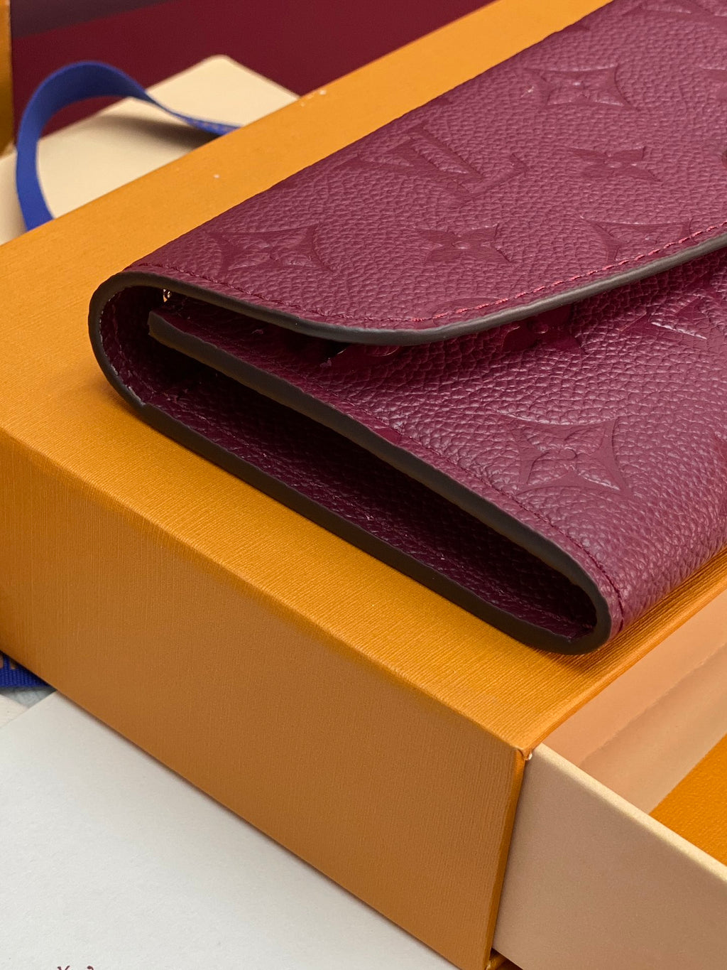 Small bag folded edge close-up, burgundy/purple interior opening on a boxed set.