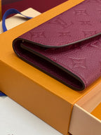 Small bag folded edge close-up, burgundy/purple interior opening on a boxed set.