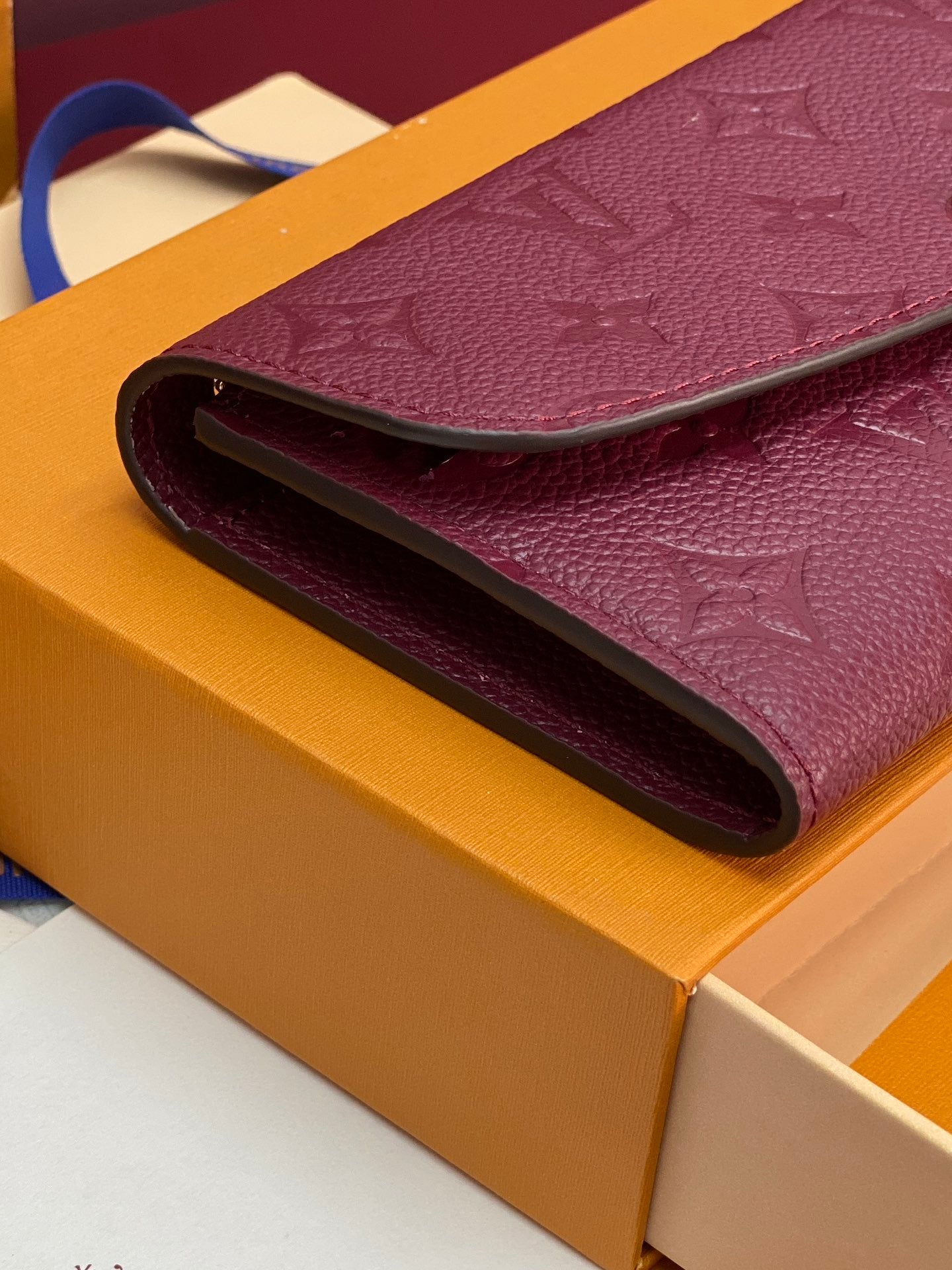 Small bag folded edge close-up, burgundy/purple interior opening on a boxed set.