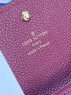 Small bag logo patch close-up: Louis Vuitton Paris with Made in France text on purple.