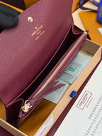Small bag interior view with burgundy/purple leather, gold zipper and card slot pocket.