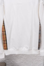White long-sleeve sweatshirt hem with ribbed cuffs, showing front panel detail