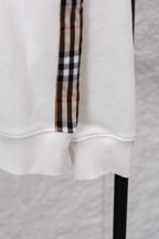 White sweatshirt cuff with ribbed hem and vertical checkered sleeve stripe