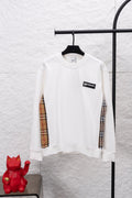 White long-sleeve sweatshirt with checkered sleeve panels and small chest logo patch