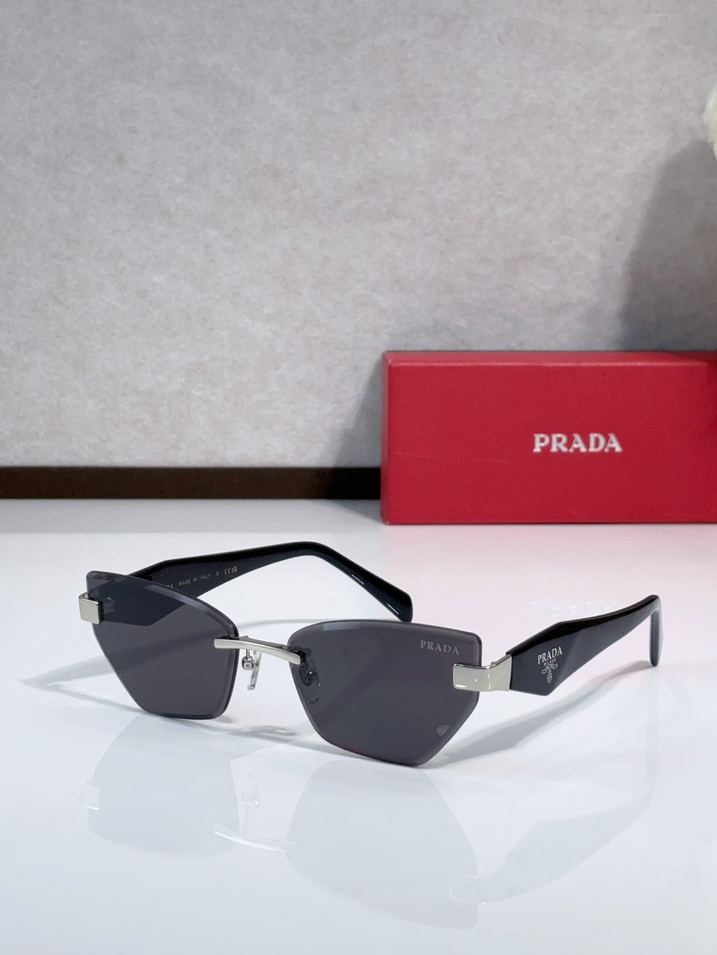 Cat-eye sunglasses with black frame, gold-tone bridge, dark lenses and black temples