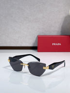 Cat-eye sunglasses with black frame and gold-tone accents, dark lenses and black temples