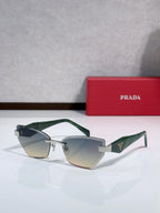Cat-eye sunglasses with green temples and gold-tone metal frame, light gray gradient lenses