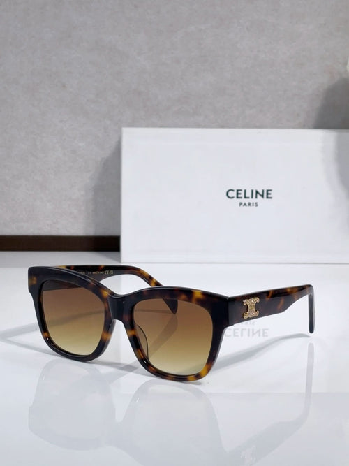 Dark tortoiseshell sunglasses with gold logo on temples and tinted gradient lenses