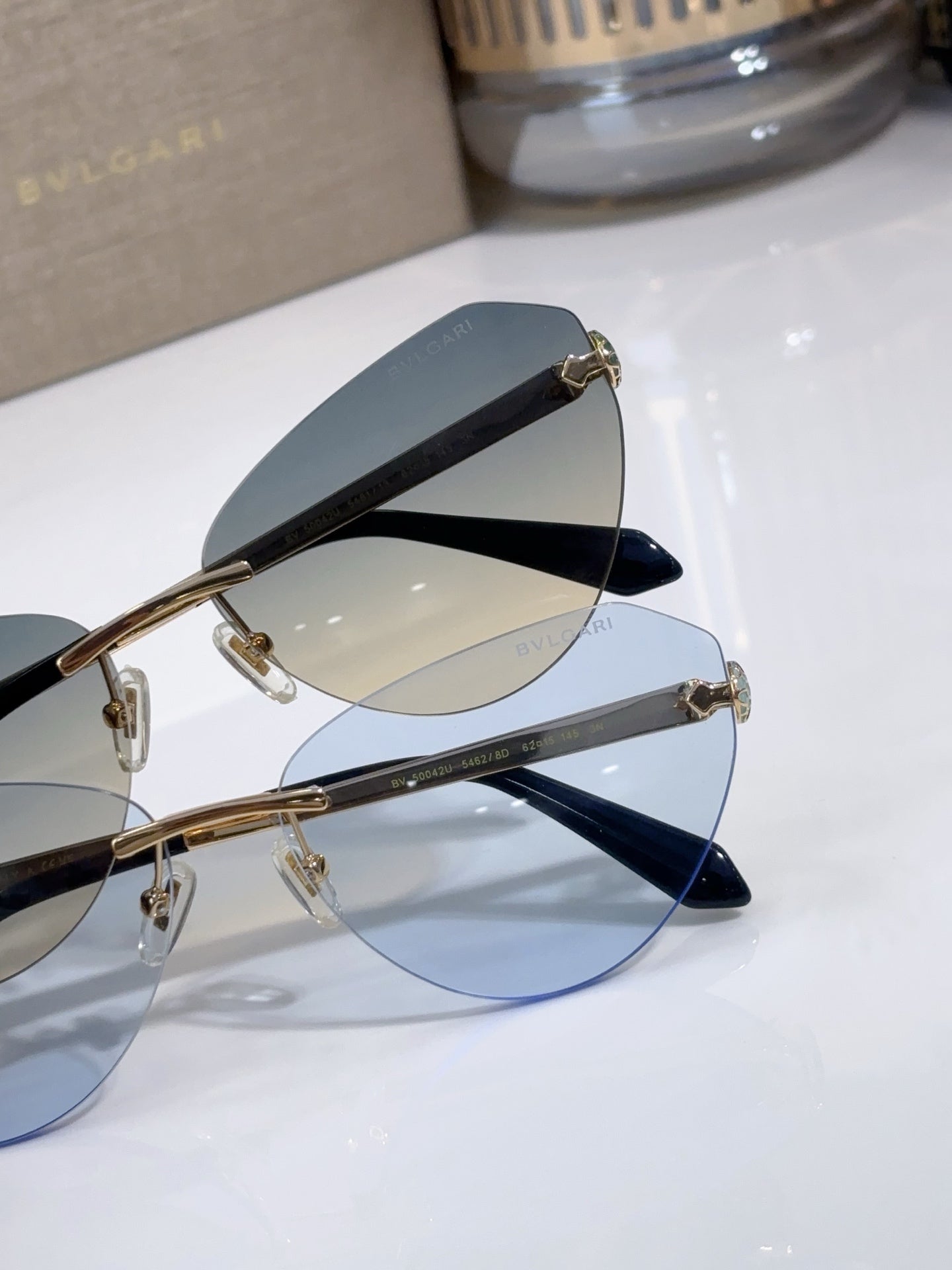 Bvlgari sunglasses close-up with blue tint lenses and gold metal frame