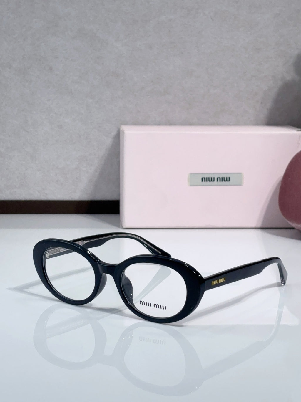 MiuMiu glasses with navy round frames and clear lenses