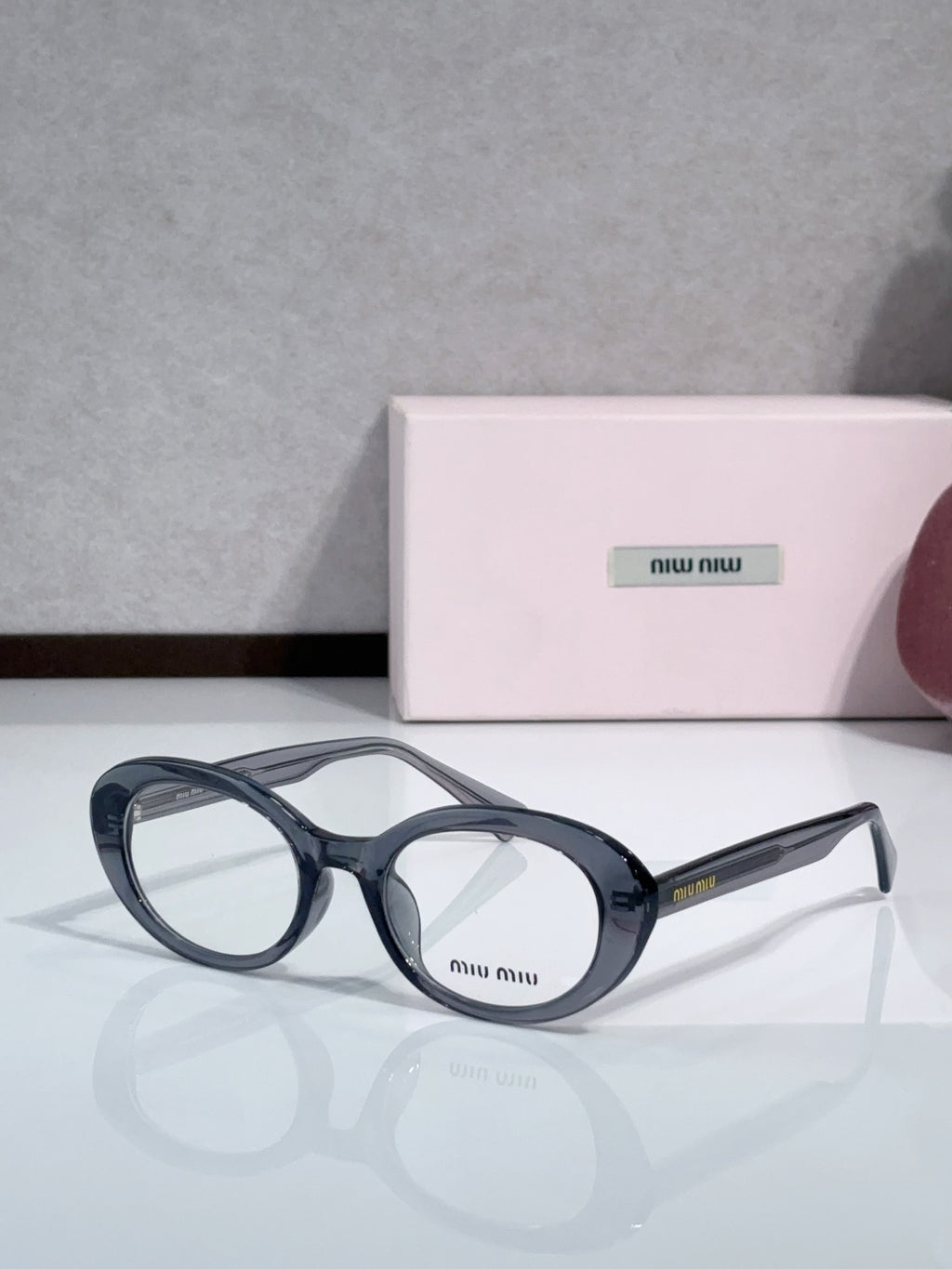 MiuMiu glasses with dark blue round frames and clear lenses