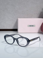 MiuMiu glasses with dark blue round frames and clear lenses