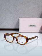 MiuMiu glasses with tortoiseshell brown round frames and clear lenses