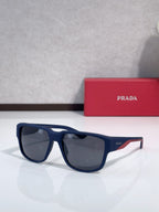Prada sunglasses, dark navy frame with dark lenses and red accent stripe on temples