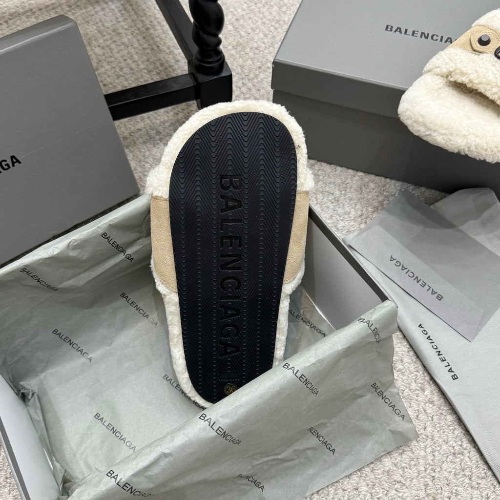 Sandal outsole view with dark textured tread and BALENCIAGA text on footbed.
