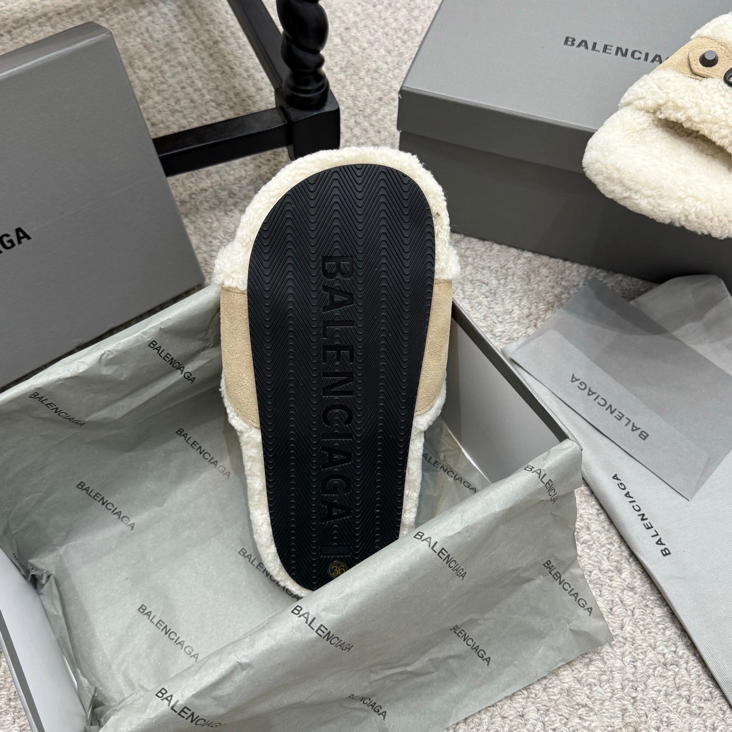 Sandal outsole view with dark textured tread and BALENCIAGA text on footbed.