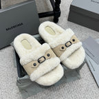 Faux-shearling slide sandals with tan strap and black buckle, cream exterior.