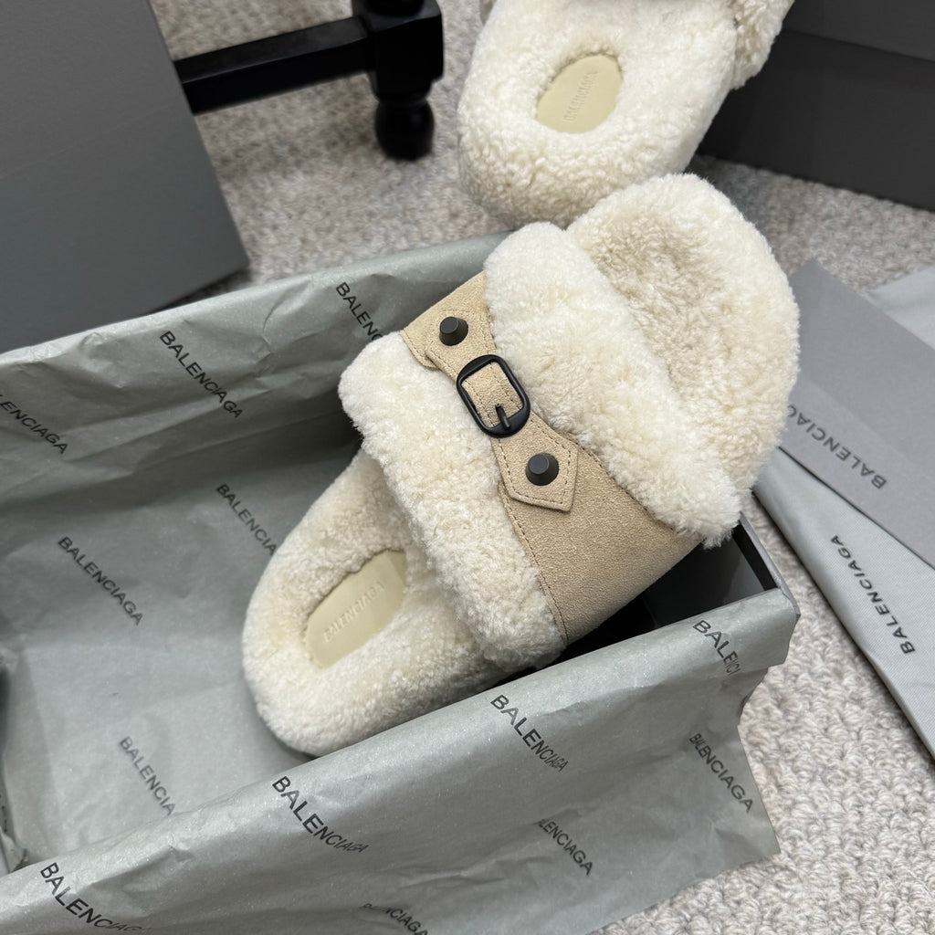 Cream open-toe sandals with tan suede panel, faux-shearling lining, and black buckle.