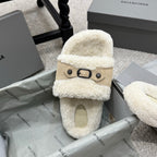 Cream faux-shearling slide sandal with tan strap and black buckle, open toe.