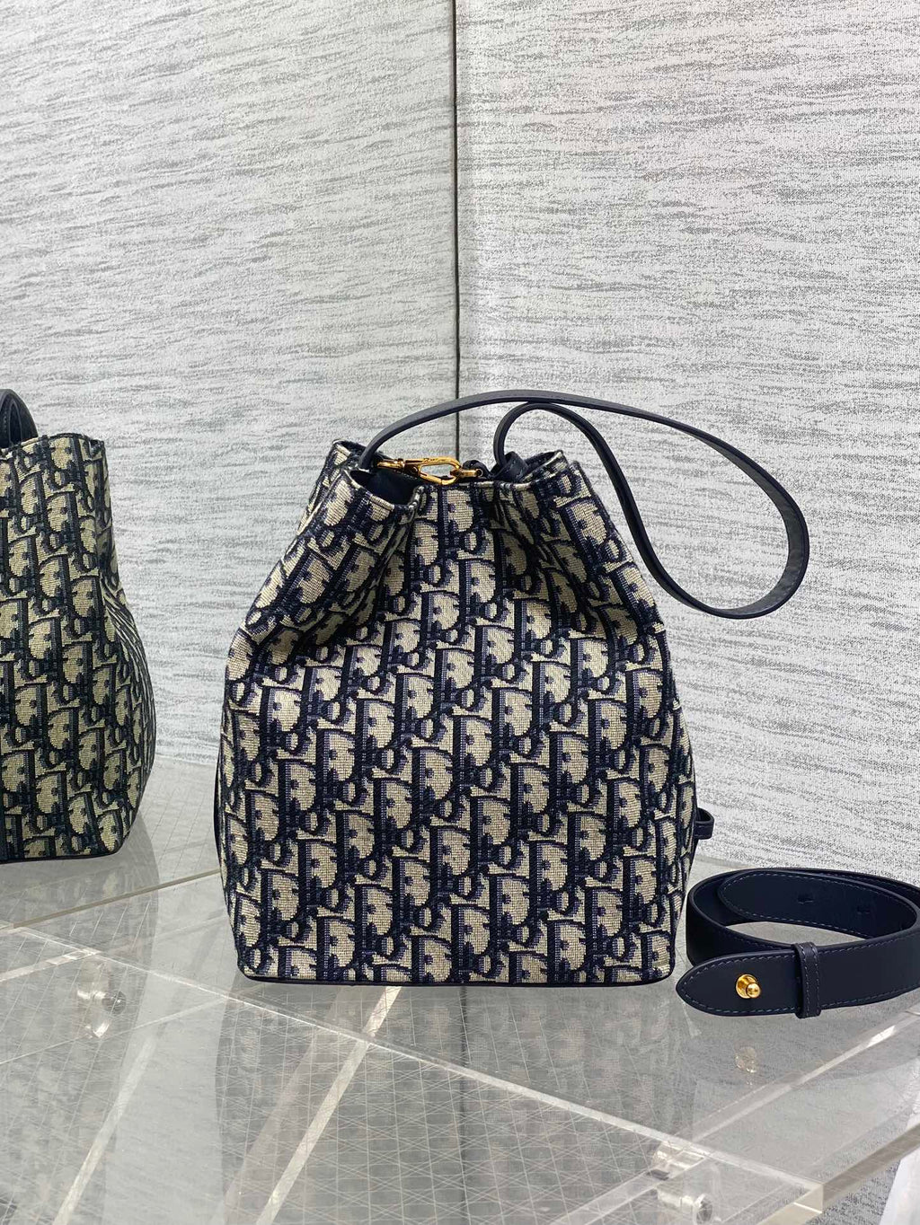 Dior Oblique canvas small bucket bag with navy top handle and wrist strap