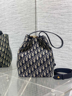 Dior Oblique canvas small bucket bag with navy top handle and wrist strap