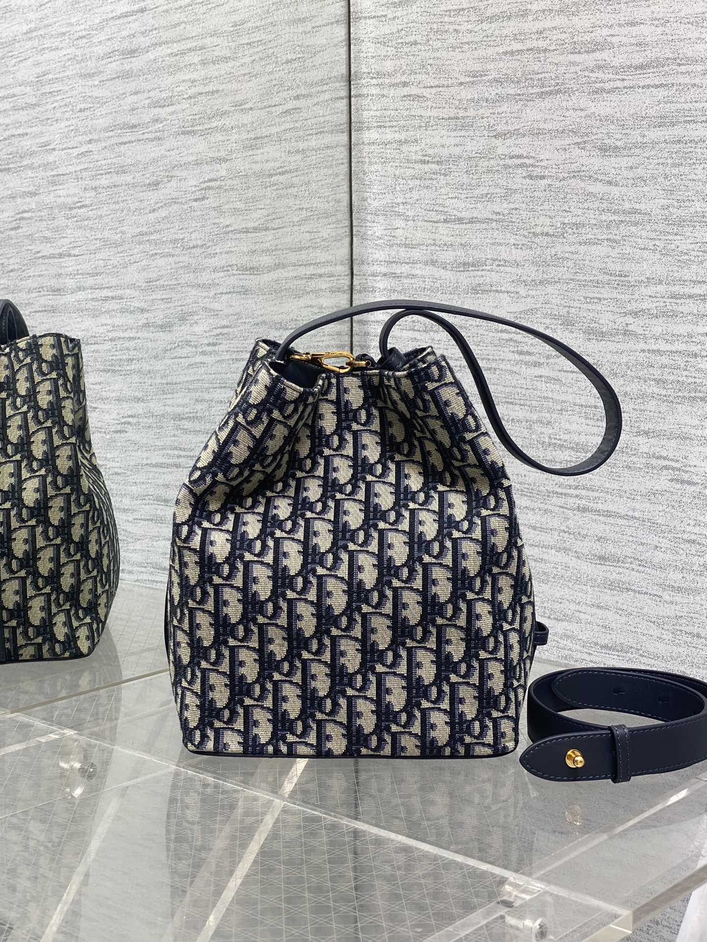 Dior Oblique canvas small bucket bag with navy top handle and wrist strap