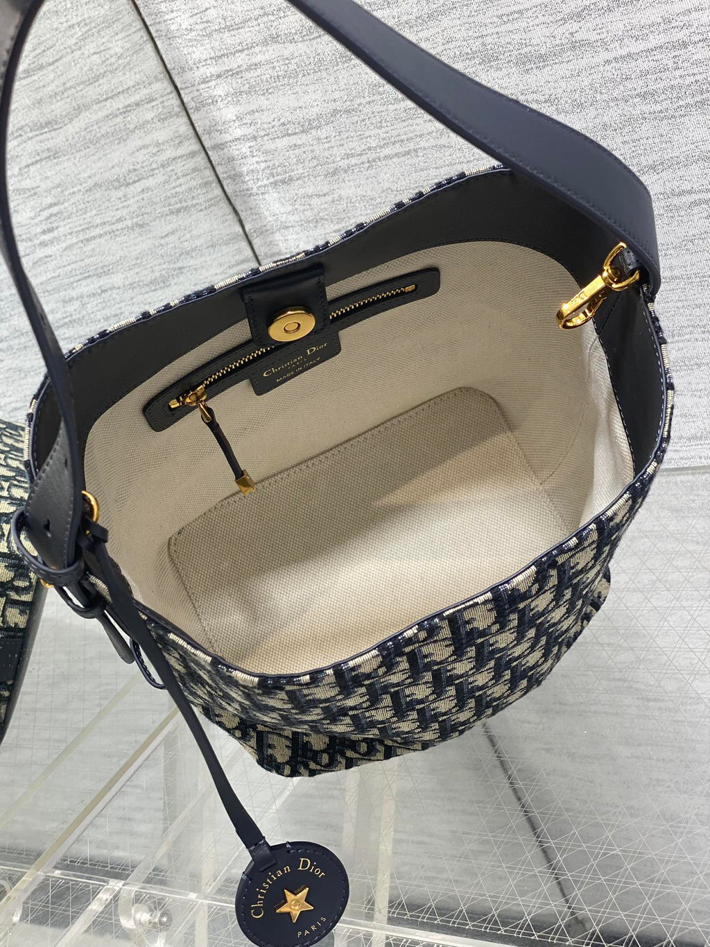 Interior of Dior Oblique crossbody bag with beige lining and zip pocket