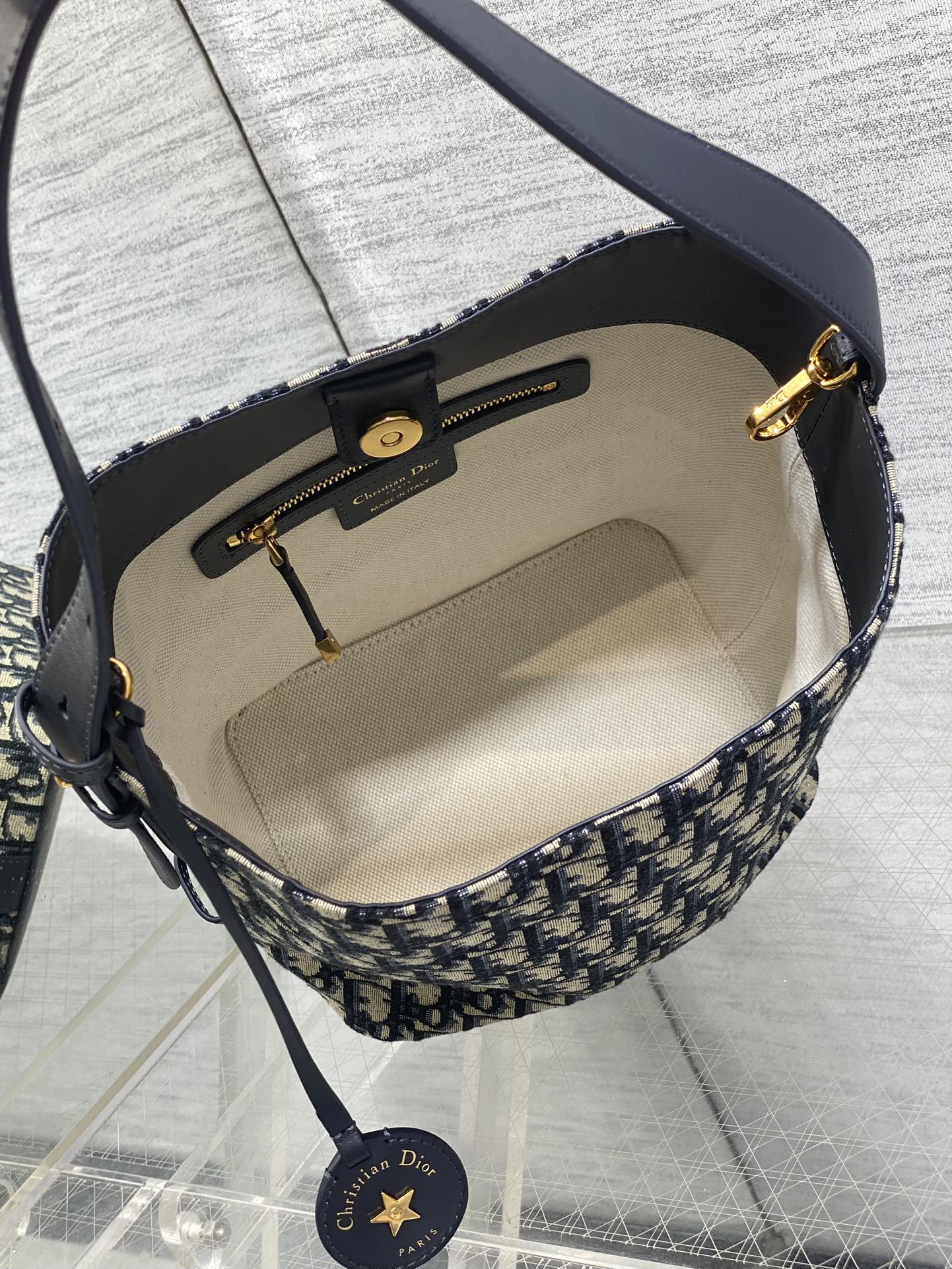 Interior of Dior Oblique crossbody bag with beige lining and zip pocket
