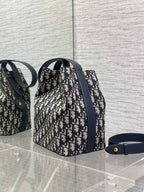 Dior Oblique canvas bucket bag with navy leather strap and gold-tone hardware