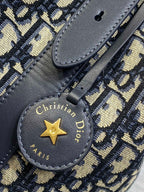 Christian Dior Paris star charm on navy leather strap with 'Made in Italy' text