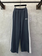 Balenciaga track pants in dark blue with white side stripes and drawstring hem