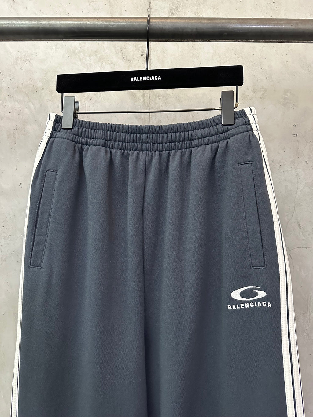 Balenciaga drawstring waist track pants in dark blue with side pockets and logo patch